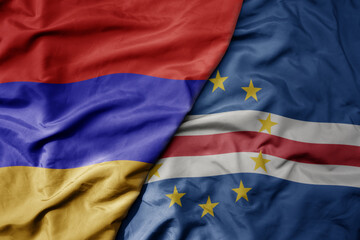 big waving national colorful flag of cape verde and national flag of armenia .