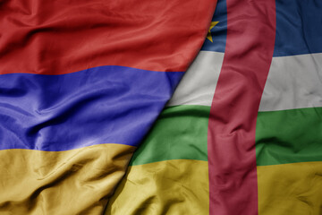 big waving national colorful flag of central african republic and national flag of armenia .