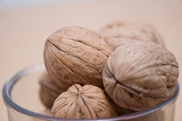 Organic Walnuts: A Rustic Display of Nature's Nutritious Bounty, Experience the rustic charm and nutritional richness with this close-up shot of organic walnuts in a glass bowl. The detailed texture