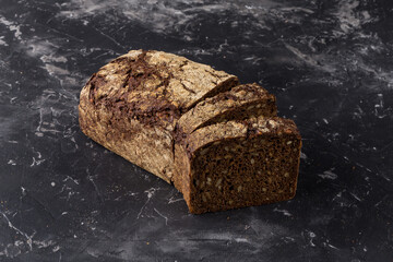 Rye bread on dark board background