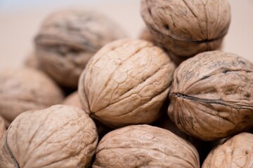 Organic Walnuts: A Close-Up of Nature's Intricate Design, Experience the beauty of nature's design with this close-up shot of organic walnuts. The central walnut, in sharp focus, reveals a texture