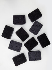 set of black sponges for washing dishes on a white background