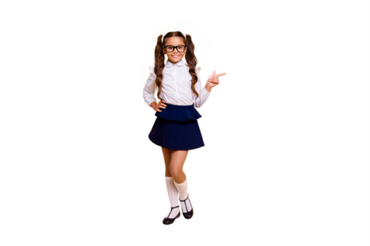 Full length, legs, body, size portrait of sweet, beautiful, small girl isolated on vivid yellow background with copy space for text points aside with the index finger and looks at the camera
