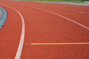Red running track in stadium as a concept sport life.