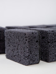 set of black sponges for washing dishes on a white background