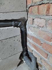 Installation of sewer pipes in the walls.