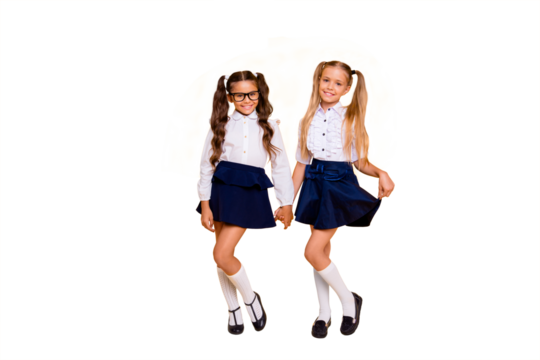Full length, legs, body, size portrait of beautiful, pretty, charming, lovely, small girls in white blouse, blue skit and black shoes stand isolated on yellow background