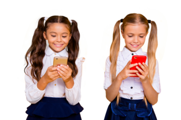 Two beautiful, pretty, charming, gorgeous small girls isolated on bright yellow background hold modern smartphones in their hands look at the screen and smile
