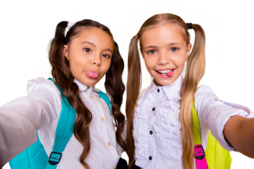 Close up portrait of lovely, sweet, adorable, beautiful, small girls make selfie on a smartphone isolated on shine yellow background look at the camera and show the tongue out