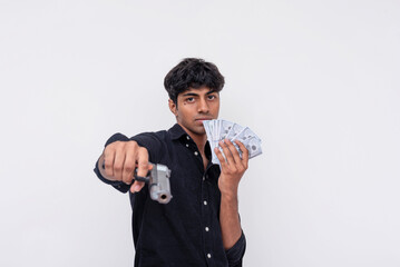 A cocky young indian man pointing a gun recklessly while flaunting some cash. Symbolizing crime and...