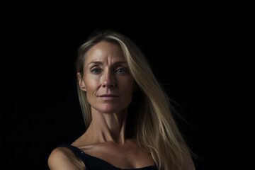 Portrait of a beautiful woman on a black background. Studio shot.
