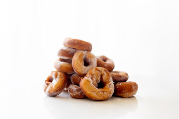 Cute school child, boy, eating doughnuts at home, homemade fresh donuts with sugar