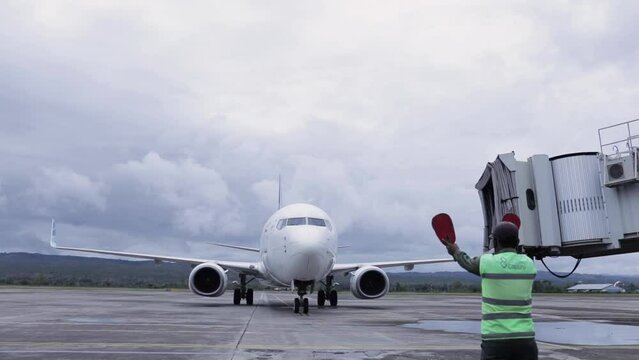 The air marshals directs an aircraft that has just landed