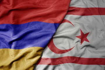big waving national colorful flag of northern cyprus and national flag of armenia .