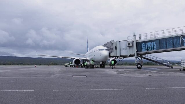The ground crew inspects the aircraft that has just landed