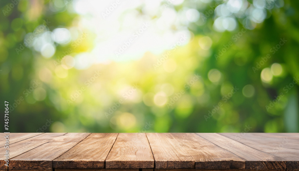 Poster empty wooden table top and abstract blurred light bokeh and blur background of garden trees in sunli