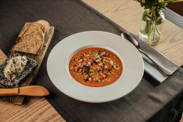 gazpacho soup with bread on table