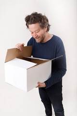 man looking inside the box he received