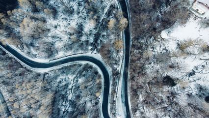 Aerial view of winding mountain road in winter.