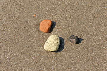 Stones of various colors rolled by sea waves on the sea beach