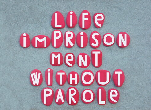 Life imprisonment is any sentence of imprisonment for a crime under which convicted criminals are to remain in prison for the rest of their natural lives, text with red painted stone letters