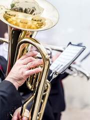 Close-up of musicians playing trumpets, focused on hands and instruments.