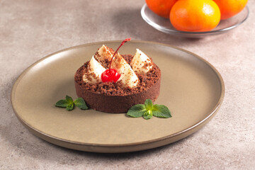Delicious chocolate tart garnish with cherry and mint. Classic dessert. - 745728482