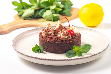 Delicious chocolate tart garnish with cherry and mint. Classic dessert. - 745728489