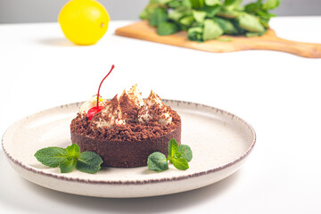 Delicious chocolate tart garnish with cherry and mint. Classic dessert. - 745728498