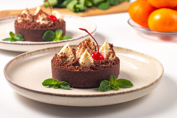 Delicious chocolate tart garnish with cherry and mint. Classic dessert. - 745728624