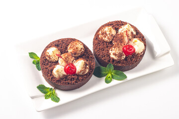 Delicious chocolate tart garnish with cherry and mint. Classic dessert. - 745728643