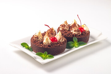 Delicious chocolate tart garnish with cherry and mint. Classic dessert. - 745728673
