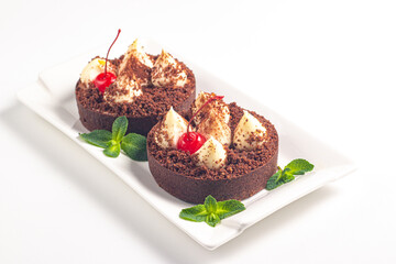 Delicious chocolate tart garnish with cherry and mint. Classic dessert. - 745728691