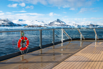 Cruise ship deck with railing in Antarctica. Snow mountain background. Winter cruise vacation...