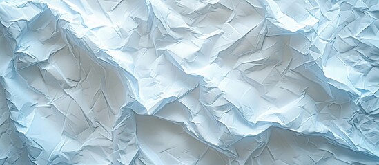 Blue and white crumpled paper background with central focus on white crumpled paper in the middle