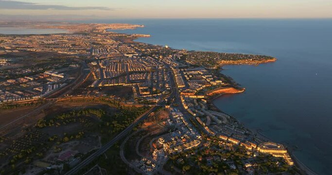 Aerial view of the beaches and coves of Cabo Roig at sunset, Alicante province, Spain