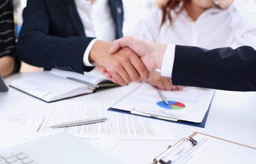 Man in suit shake hand as hello in office