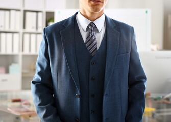 Male arm in blue suit set tie closeup