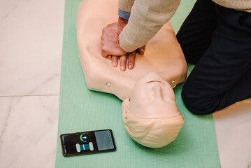 Indirect heart massage. Automated external defibrillator device, AED with training dummy mannequin....