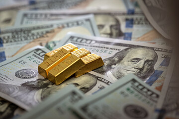 group gold bars and paper dollar bills as financial background