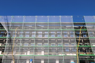 Protective netting on construction scaffolding