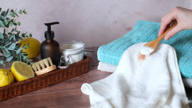 A woman using baking soda removing a stain on clothes. Eco-conscious and environmentally friendly. Zero waste concept. 4k, video