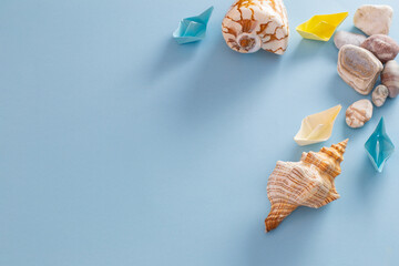 summer sea background with paper boats, stones and seashell