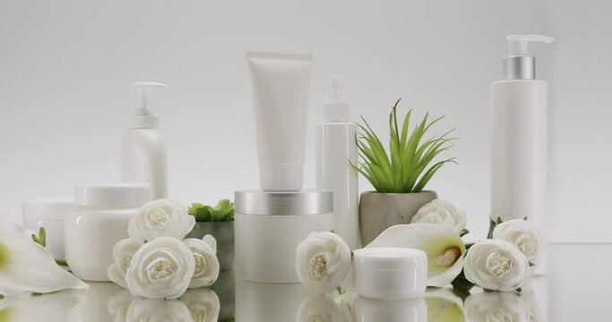 Set of professional cosmetic for skin care. Advertising concept of beauty products, cleansing gel, anti wrinkles cream, hydrating lotion and moisturizer with rose flowers on white background