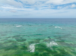 Ocean waves and corals reefs with turquoise water. Blue sea in Santa Fe, Tablas, Romblon....