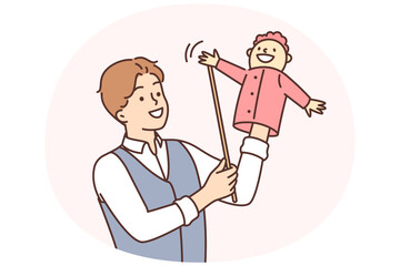 Man puppeteer is preparing to go on stage to show children theater with hand-operated puppets