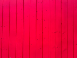 dyed red color wood planks texture, background. house exterior decoration