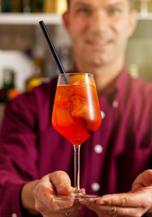Bartender presenting aperol spritz cocktail - 745773807
