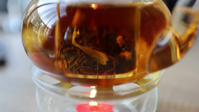 The video features tea leaves gracefully swirling in a teapot, creating a soothing and mesmerizing dance. The gentle infusion captures the essence of tea-making.