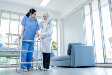 Healthcare, A Muslim Female doctor help a patient who is doing physical therapy and is practicing...